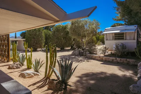 a front view of a house with a glass top table and chairs