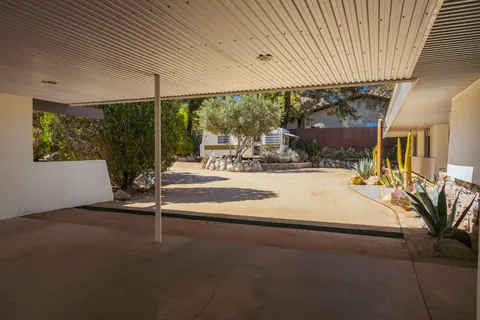 an aerial view of a house with a yard and garden