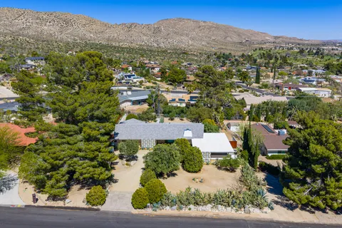 an aerial view of a house with a yard and garden
