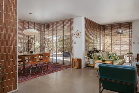 a view of a dining room with furniture window and outside view