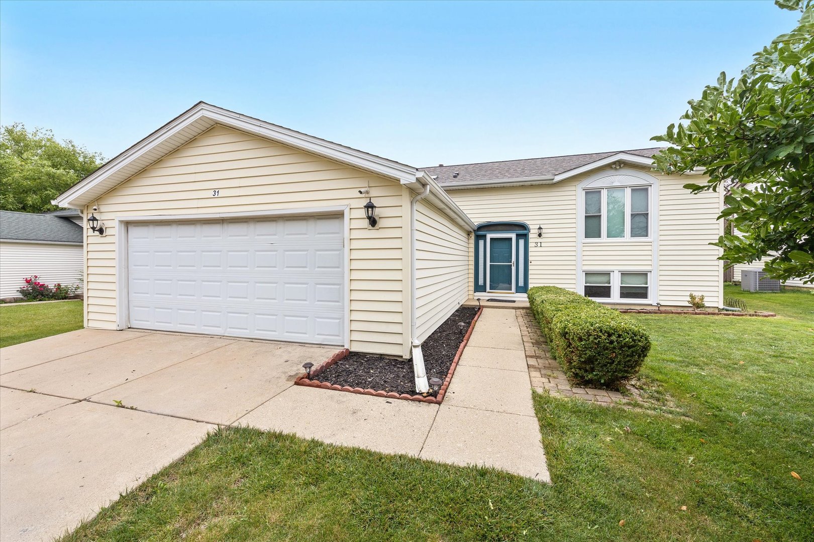 31 Evergreen Road Streamwood, IL 60107 - Photo 1 of 22 a front view of a house with a yard