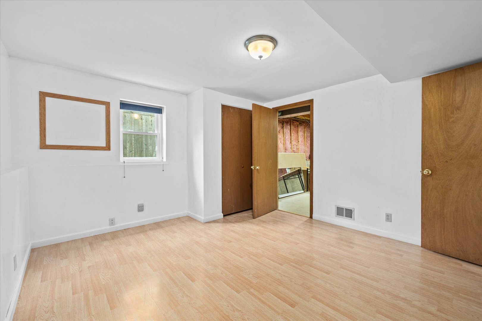 31 Evergreen Road Streamwood, IL 60107 - Photo 18 of 22 a view of an empty room with wooden floor and a window