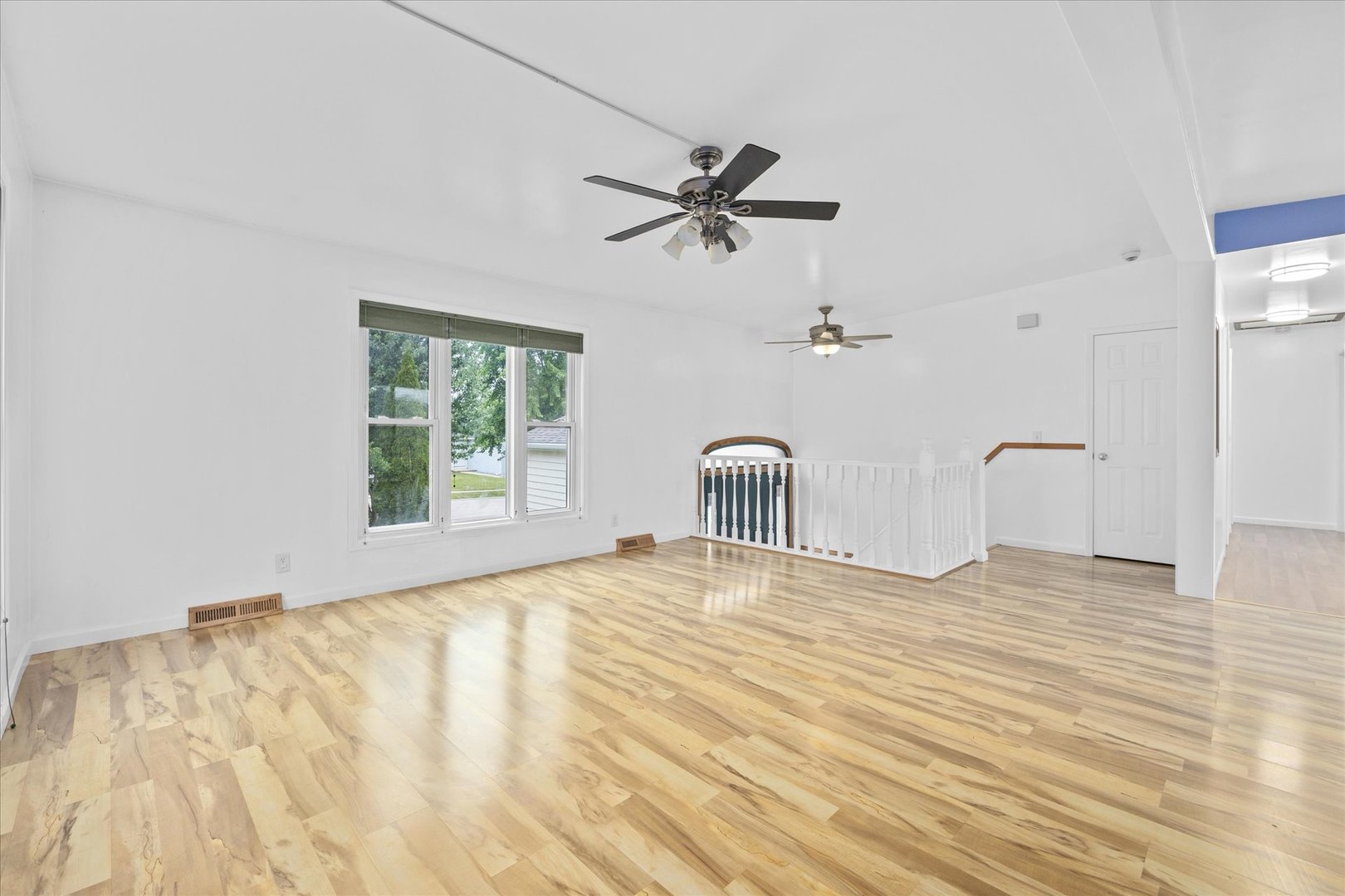 31 Evergreen Road Streamwood, IL 60107 - Photo 4 of 22 a view of empty room with wooden floor and fan