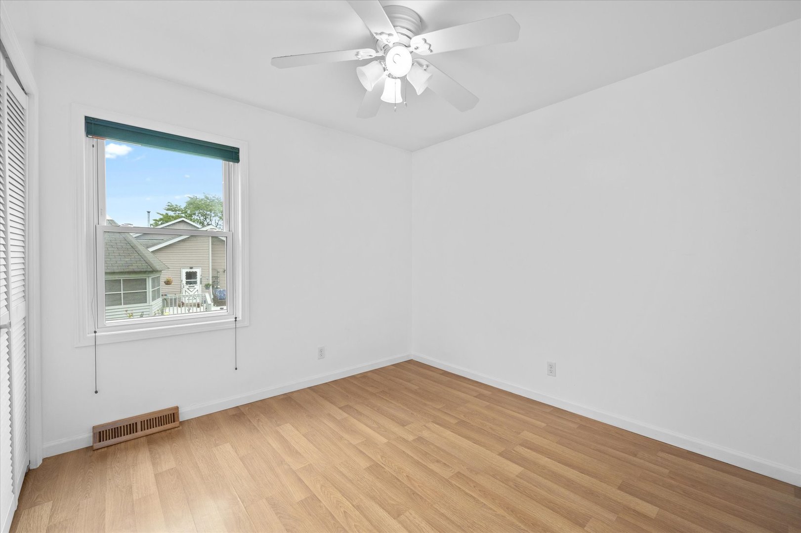 31 Evergreen Road Streamwood, IL 60107 - Photo 8 of 22 an empty room with a window and a chandelier fan