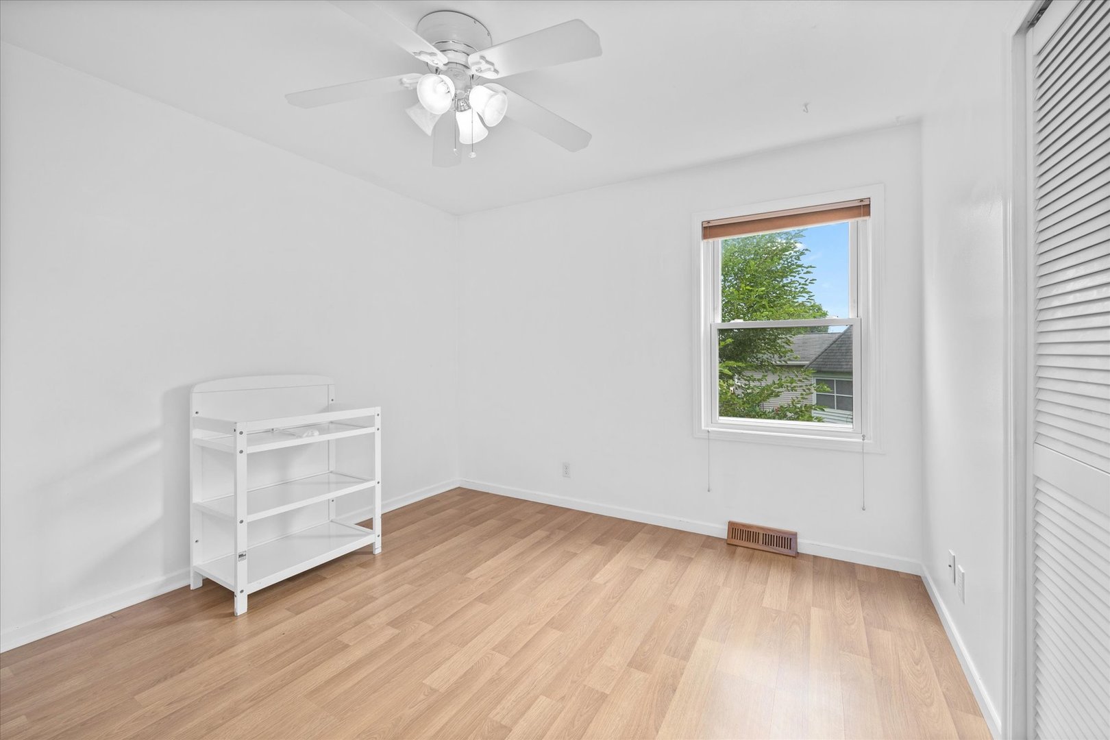 31 Evergreen Road Streamwood, IL 60107 - Photo 9 of 22 an empty room with a hardwood and ceiling fan