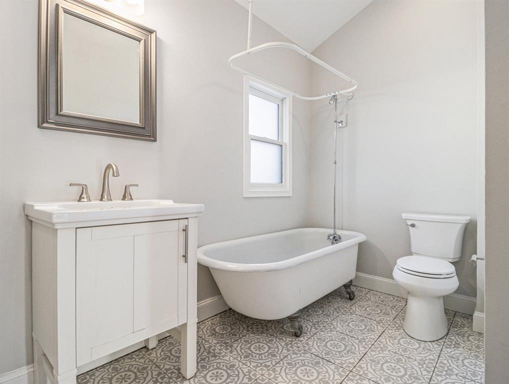 74 Boulevard Southeast Atlanta, GA 30312 - Photo 7 of 11 a spacious bathroom with a toilet sink and mirror