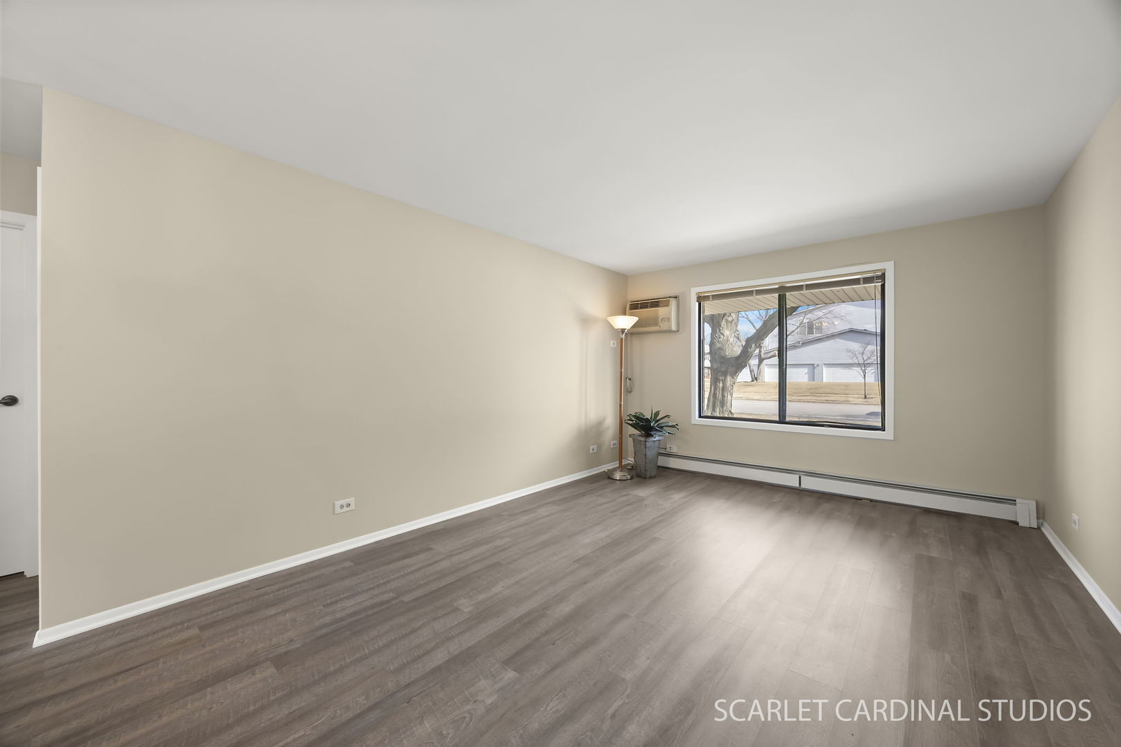 465 Echo Lane, Unit 2 Aurora, IL 60504 - Photo 2 of 12 an empty room with wooden floor and windows