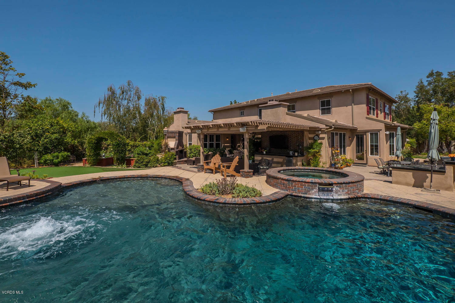 782 Running Creek Simi Valley, CA 93065 - Photo 44 of 49 a front view of a house with garden and swimming pool
