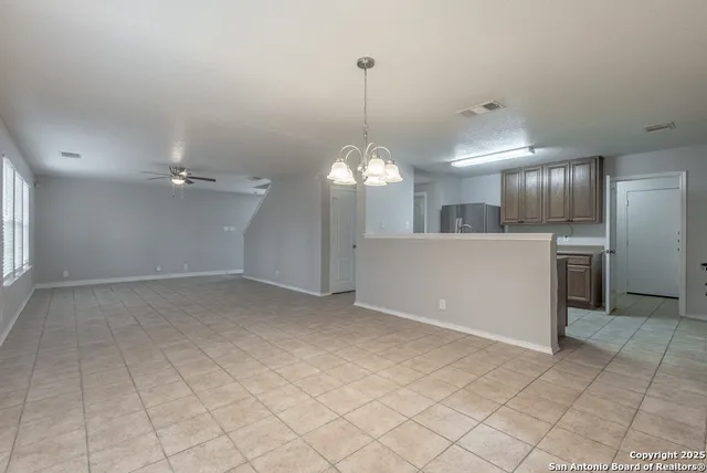 a view of a kitchen with a sink cabinets and stainless steel appliances