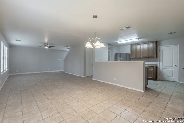 a view of a kitchen with a sink cabinets and stainless steel appliances