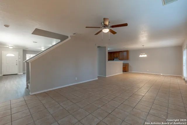 a view of a livingroom with a ceiling fan and window