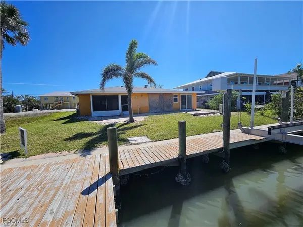 a view of a house with backyard and sitting area