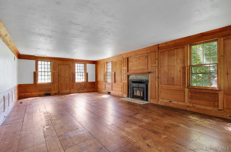 208 Woodcreek Road Bethlehem, CT 06751 - Photo 10 of 29 an empty room with windows fire place and outdoor view