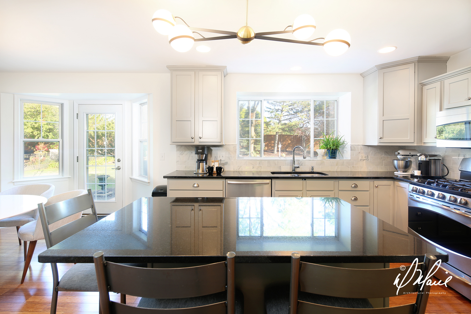 5047 Prairie Sage Lane Naperville, IL 60564 - Photo 6 of 22 a kitchen with kitchen island a stove a table and chairs in it