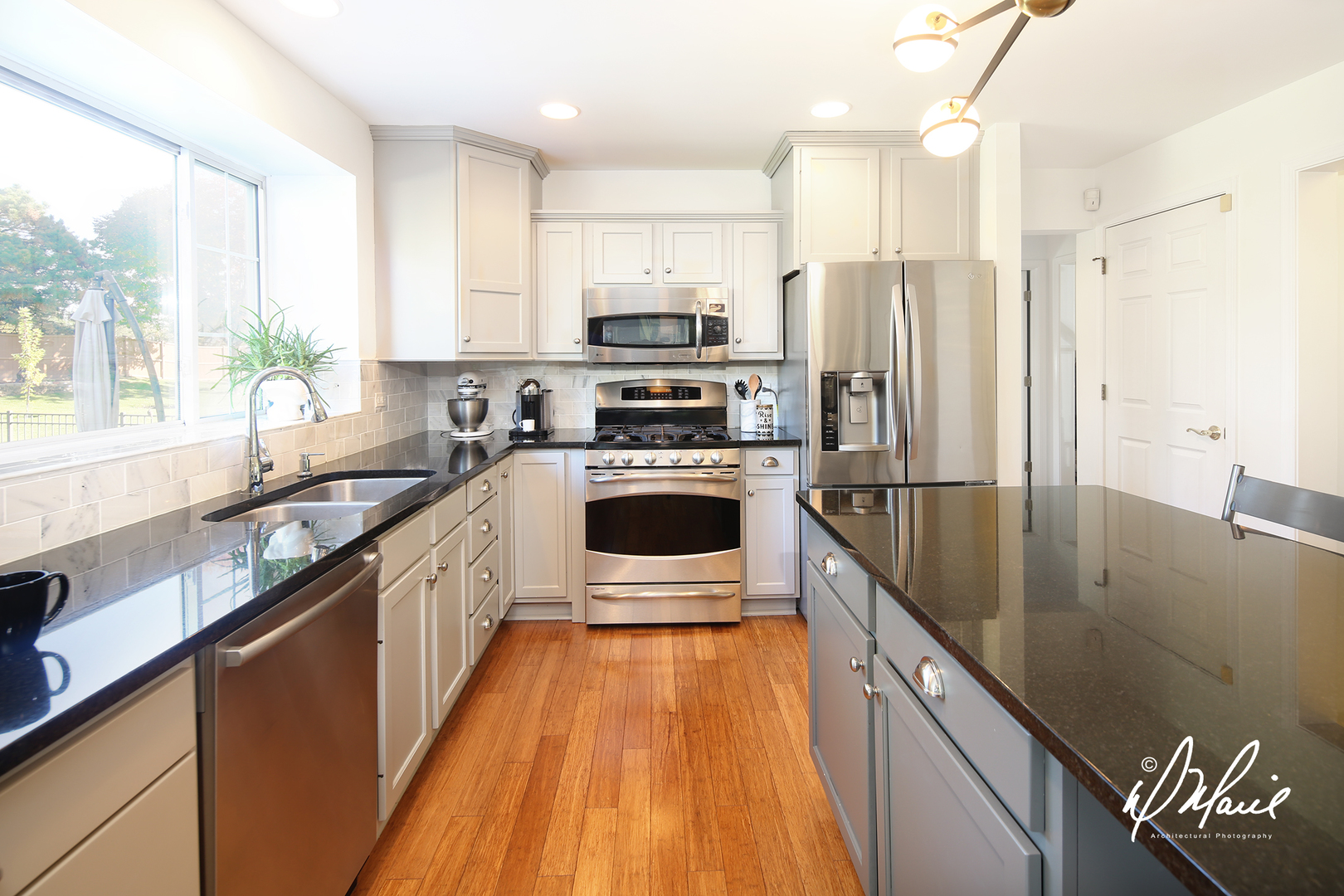 5047 Prairie Sage Lane Naperville, IL 60564 - Photo 8 of 22 a kitchen with stainless steel appliances a refrigerator sink and white cabinets
