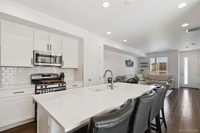 a kitchen with a stove a sink and a refrigerator
