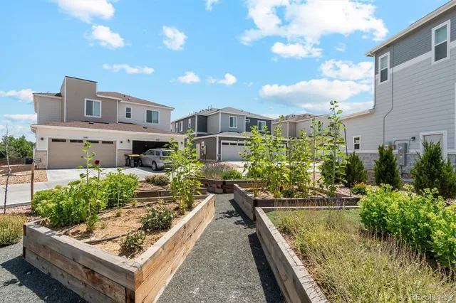 a view of a house with swimming pool and sitting area