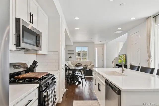 a kitchen with a stove a sink and a refrigerator
