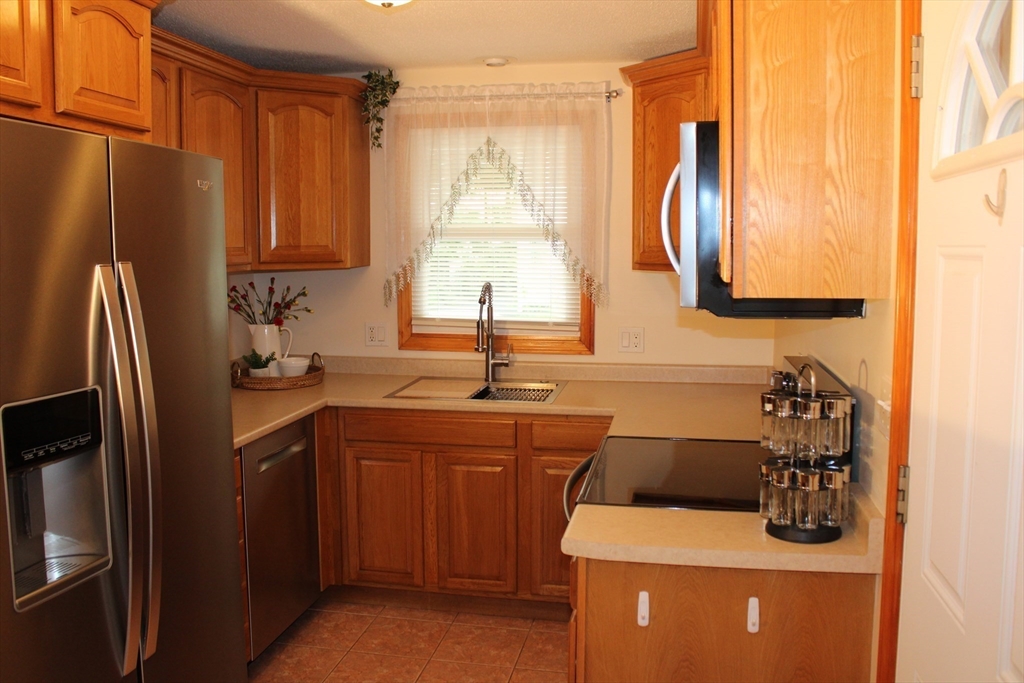 28 State Street Chicopee, MA 01013 - Photo 5 of 25 a kitchen with a sink a refrigerator and a sink