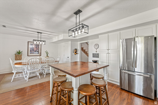 246 West Mount Charm Road Toquerville, UT 84774 - Photo 18 of 70 Kitchen with freestanding refrigerator, wooden counters, a textured ceiling, white cabinets, and dark wood-style floors