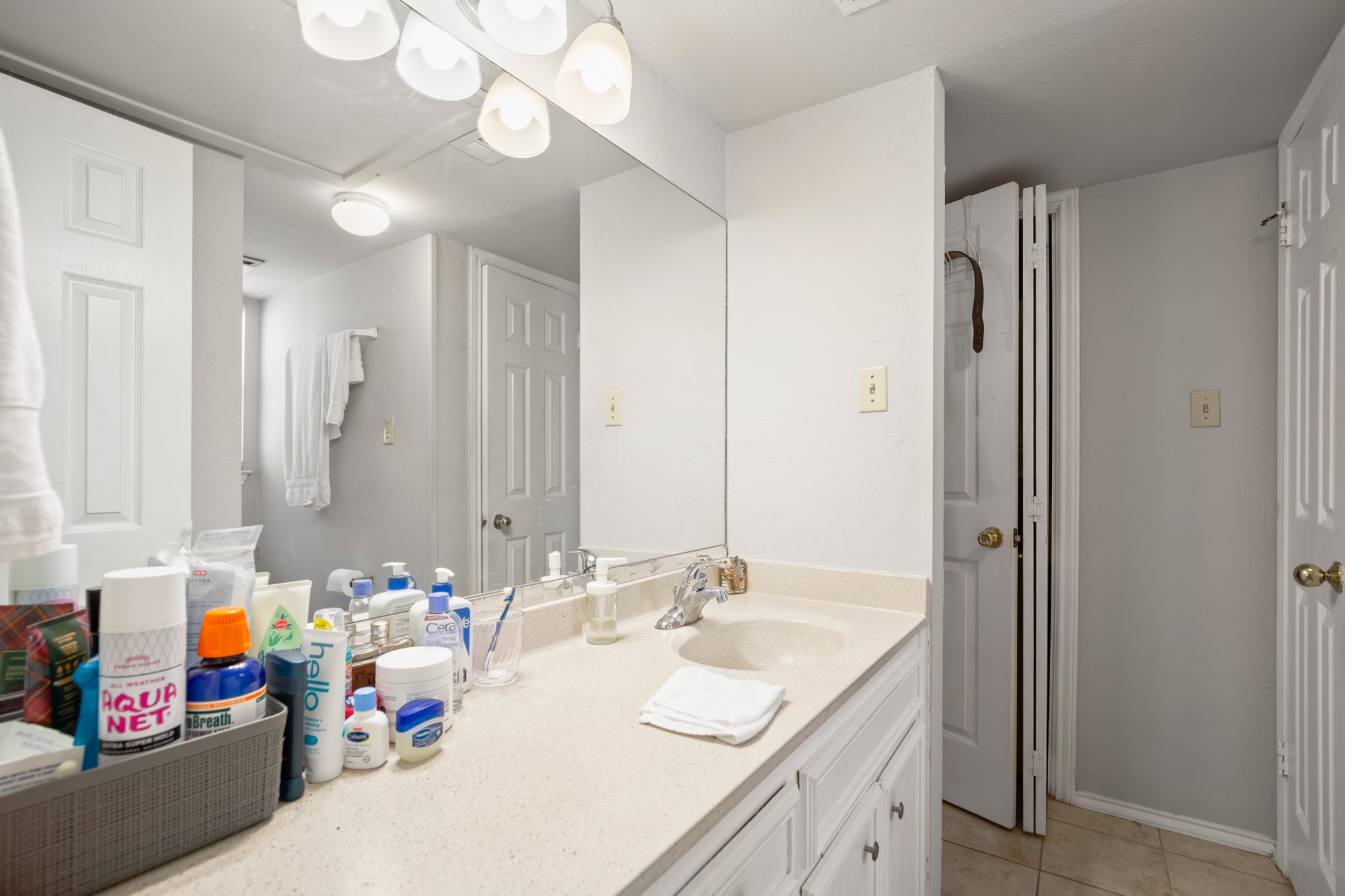 706 West 22nd Street, Unit 206 Austin, TX 78705 - Photo 7 of 18 Bathroom with vanity and light tile patterned floors