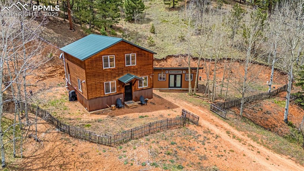 325 Willow Road Divide, CO 80814 - Photo 3 of 45 a aerial view of a house with a yard covered in snow
