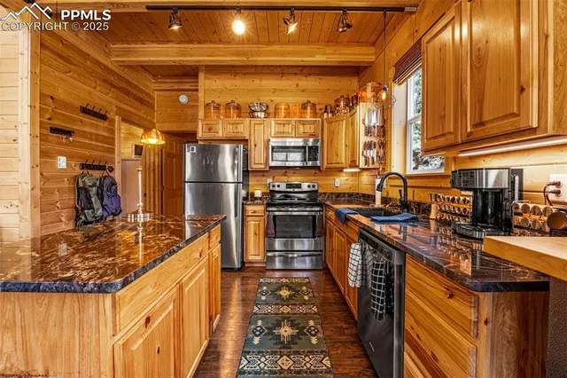 a kitchen with lots of counter top space and stainless steel appliances