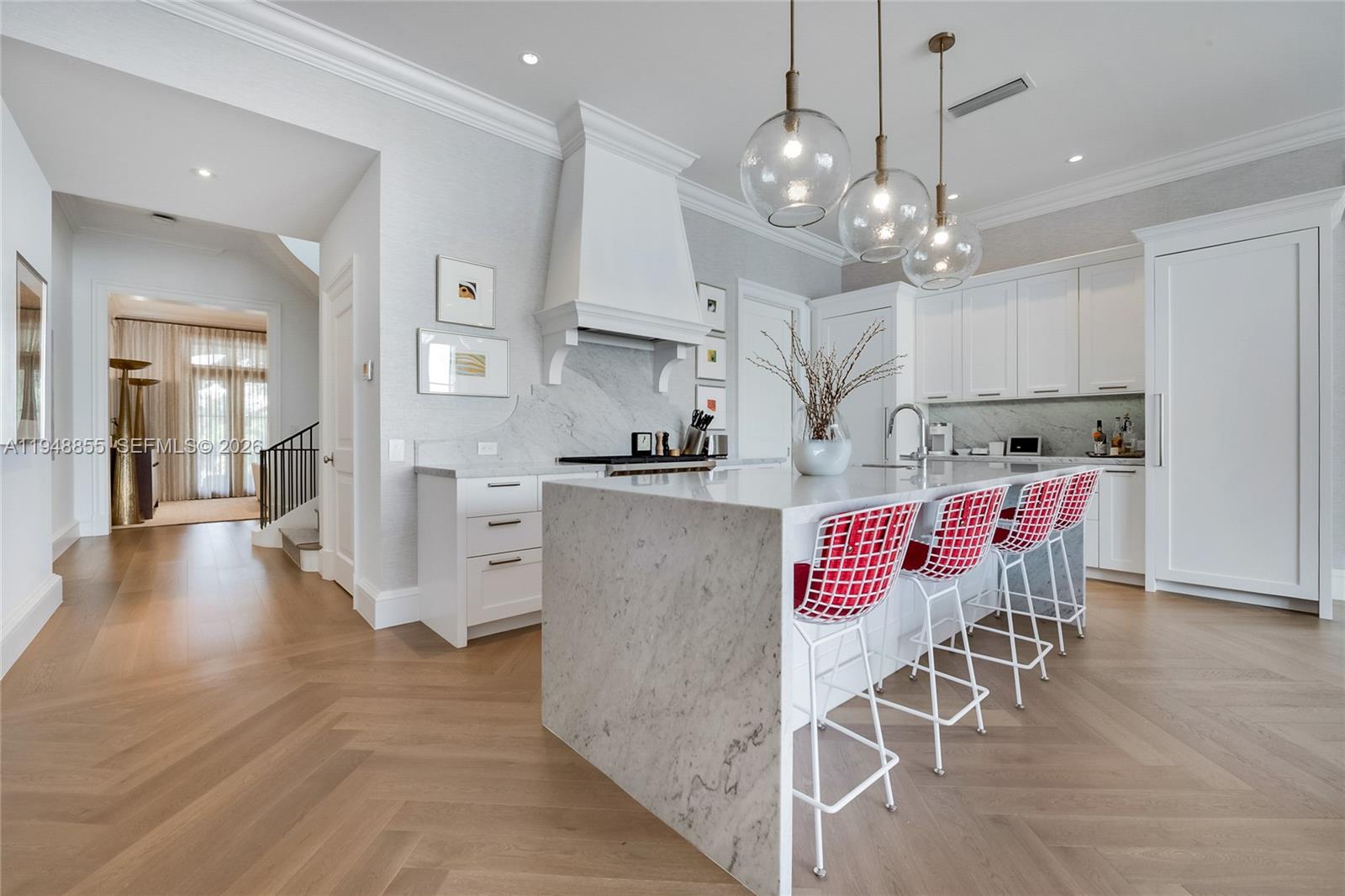 2615 Anderson Road Coral Gables, FL 33134 - Photo 11 of 28 a kitchen with stainless steel appliances granite countertop a refrigerator a stove top oven a sink a dining table and chairs with wooden floor