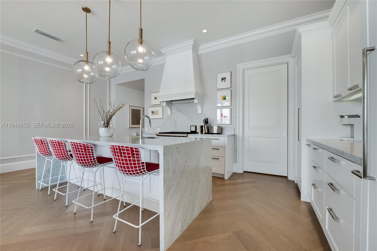 2615 Anderson Road Coral Gables, FL 33134 - Photo 12 of 28 a kitchen with stainless steel appliances granite countertop a stove a sink a refrigerator and white cabinets with wooden floor
