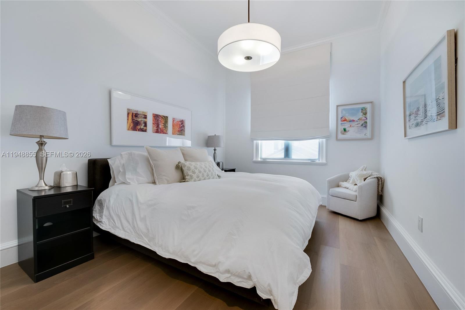 2615 Anderson Road Coral Gables, FL 33134 - Photo 20 of 28 a bedroom with a bed and a chandelier