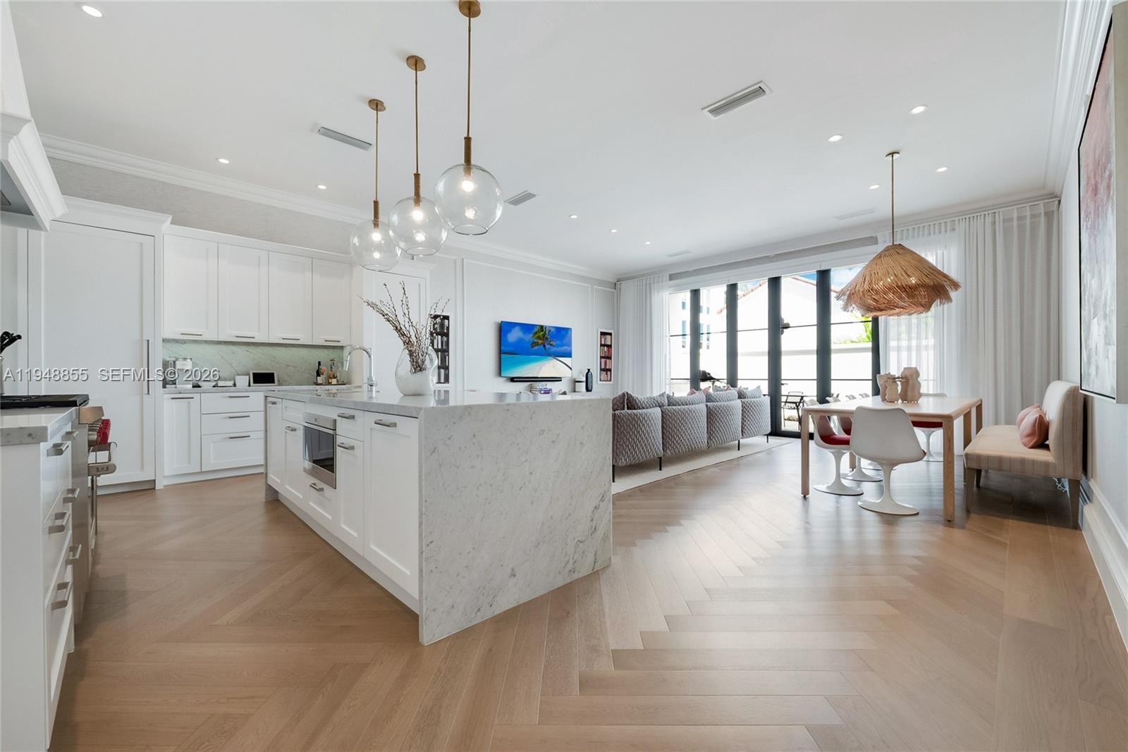 2615 Anderson Road Coral Gables, FL 33134 - Photo 9 of 28 a large white kitchen with lots of white furniture and chandelier