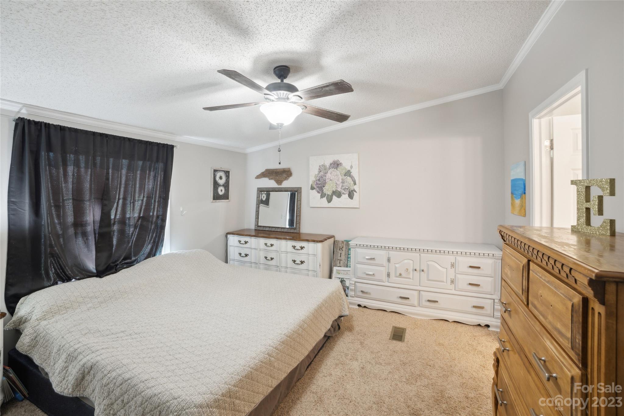 235 Amity Church Road Iron Station, NC 28080 - Photo 12 of 25 a spacious bedroom with a bed and a window