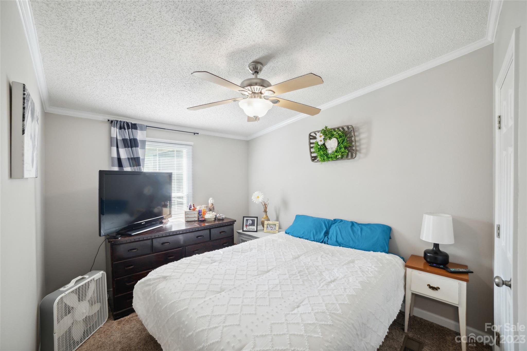 235 Amity Church Road Iron Station, NC 28080 - Photo 17 of 25 a bedroom with a bed and a flat screen tv