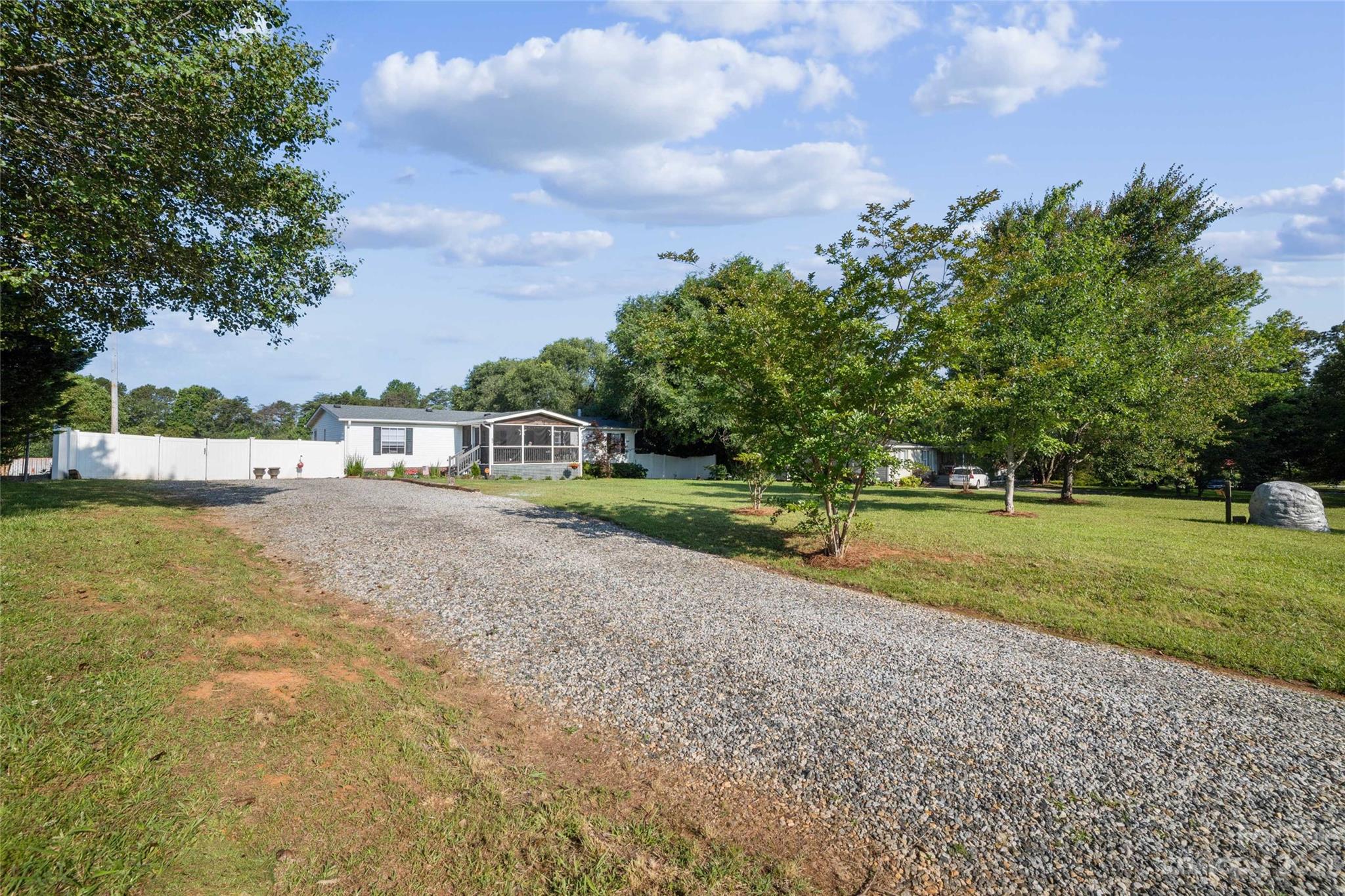 235 Amity Church Road Iron Station, NC 28080 - Photo 2 of 25 a view of house with swimming pool and green space