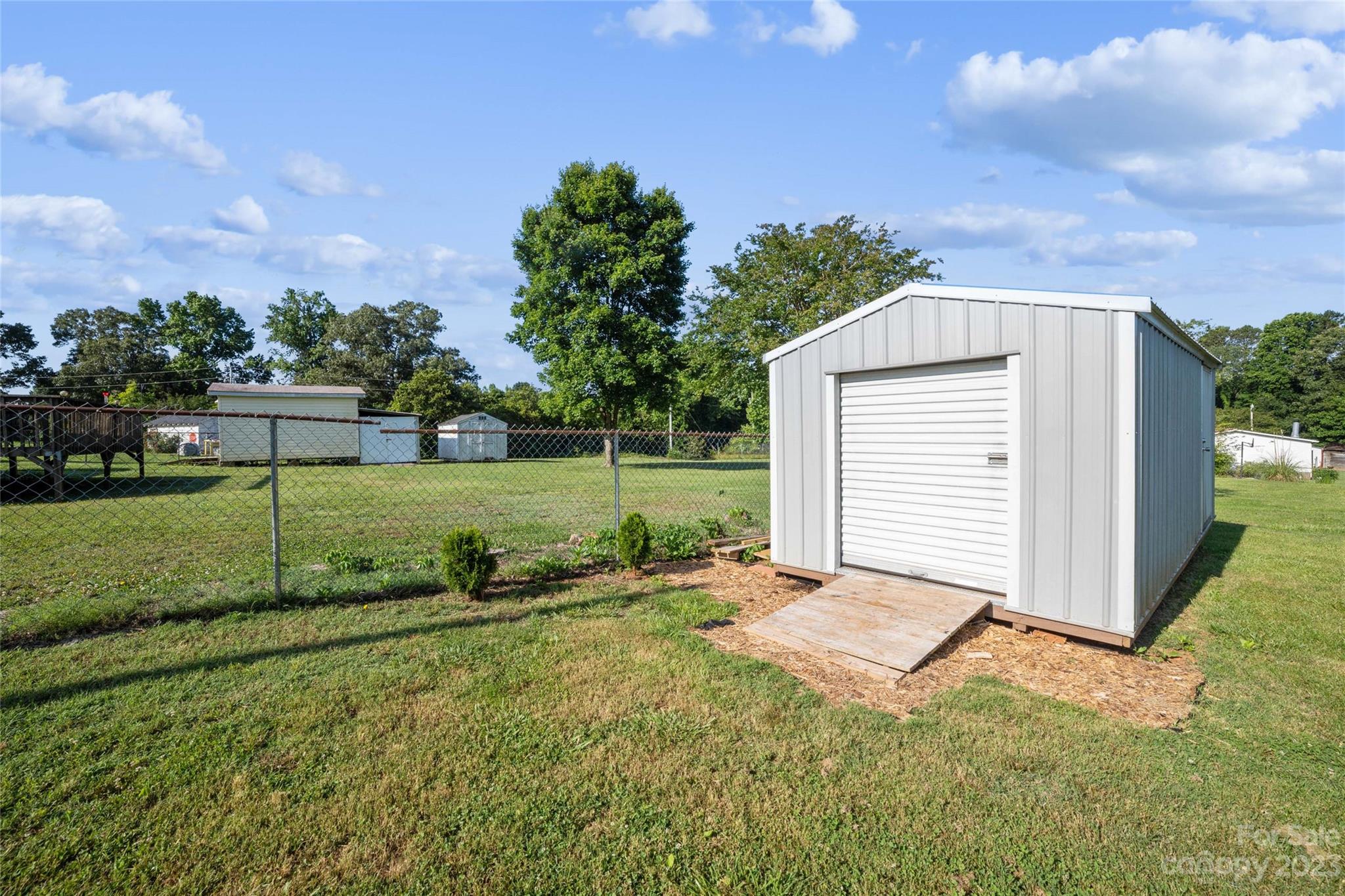 235 Amity Church Road Iron Station, NC 28080 - Photo 22 of 25 a view of a house with backyard and trees