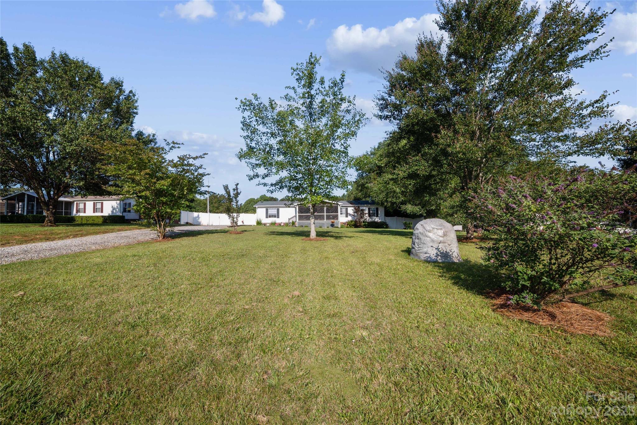 235 Amity Church Road Iron Station, NC 28080 - Photo 3 of 25 a view of a house with a yard