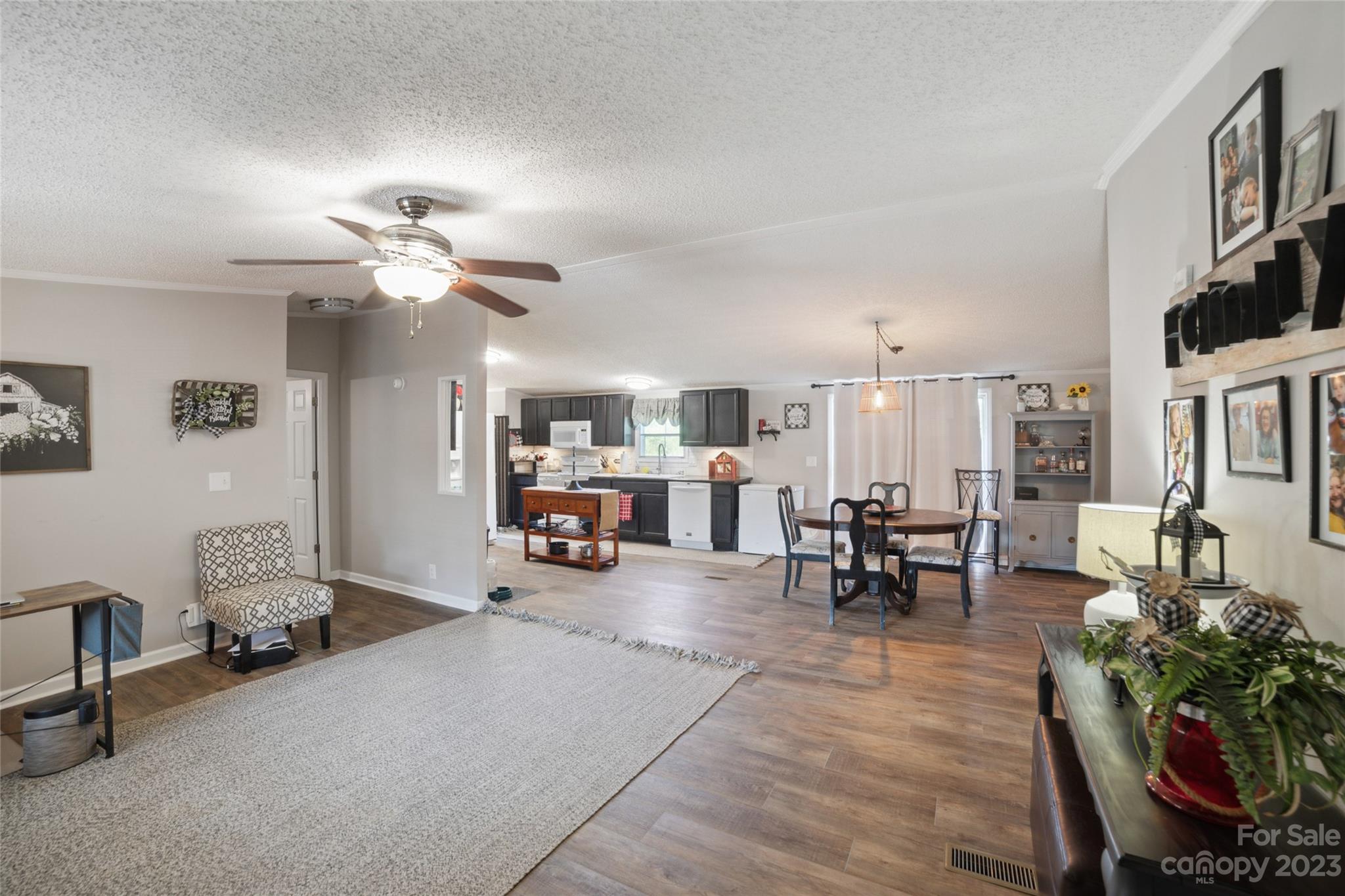 235 Amity Church Road Iron Station, NC 28080 - Photo 4 of 25 a living room with furniture a dining table and chairs with wooden floor