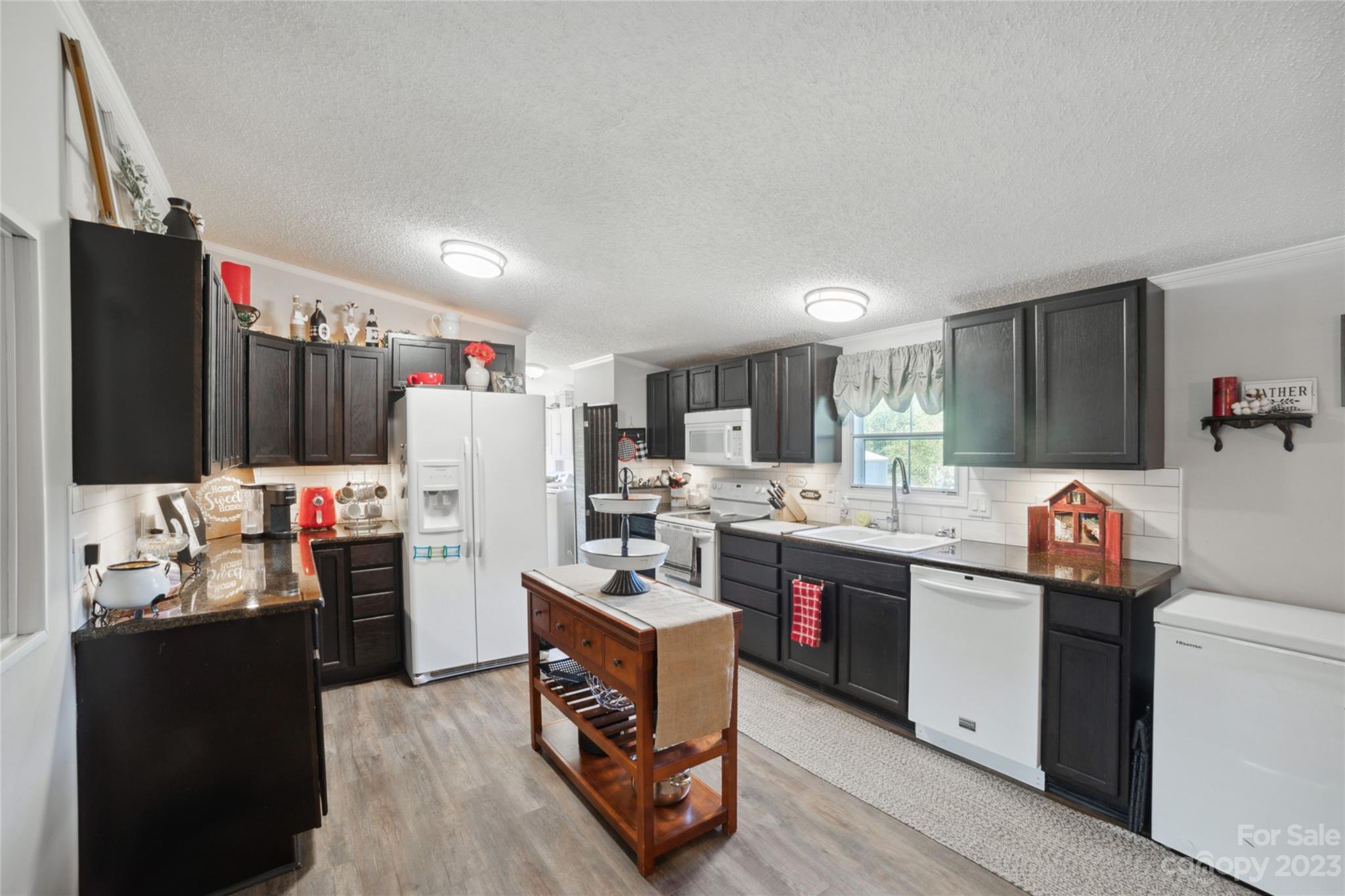 235 Amity Church Road Iron Station, NC 28080 - Photo 7 of 25 a kitchen with refrigerator and cabinets
