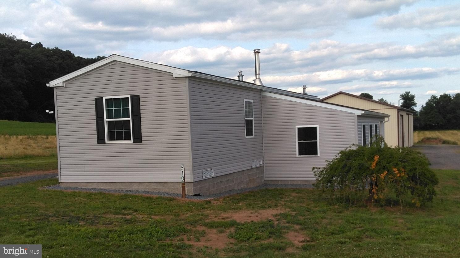 510 School Road Denver, PA 17517 - Photo 3 of 14 a view of a backyard with plants and a large tree
