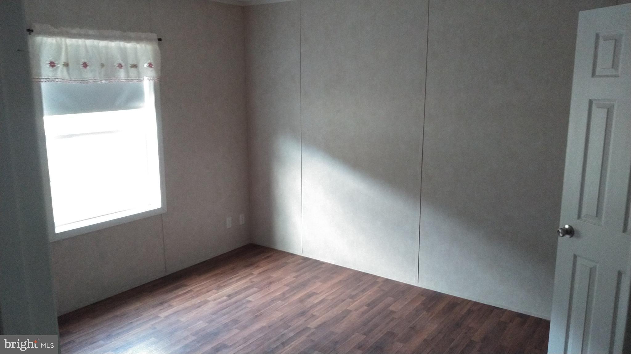 510 School Road Denver, PA 17517 - Photo 7 of 14 an empty room with wooden floor and windows