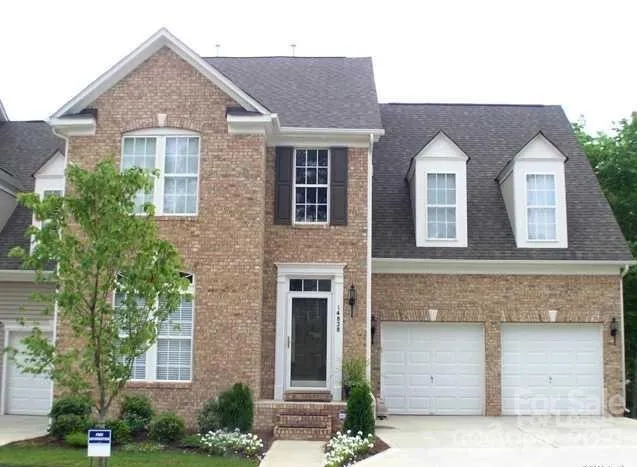 a front view of house with yard and parking