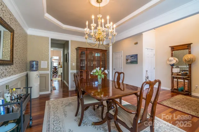 a view of a dining room with furniture and chandelier