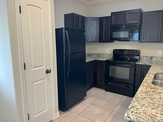 a kitchen with a refrigerator and a stove