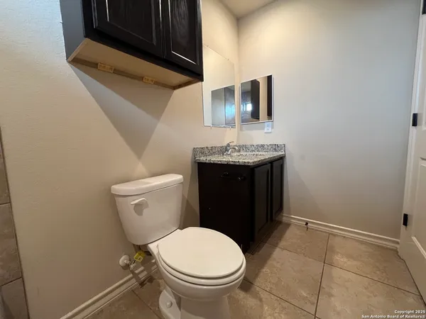 a bathroom with a toilet a sink and mirror