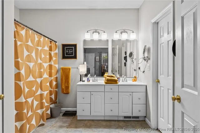 a view of bathroom with dual sinks