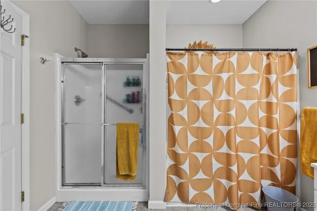 a bathroom with a shower and a shower curtain