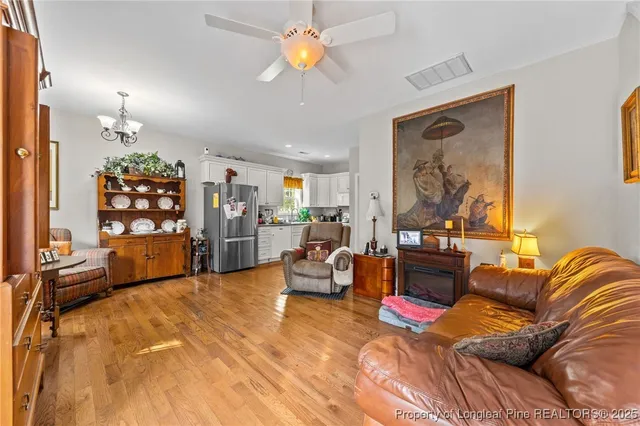 a living room with furniture a lamp and a window