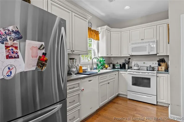a kitchen with stainless steel appliances a stove a sink and a refrigerator