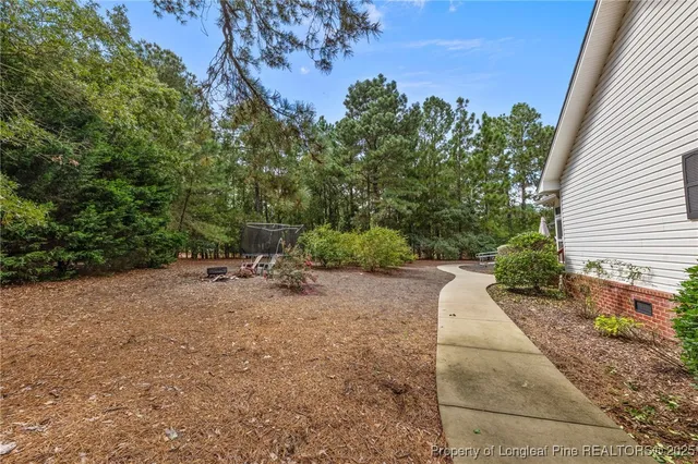 a view of a house with a yard and a garden