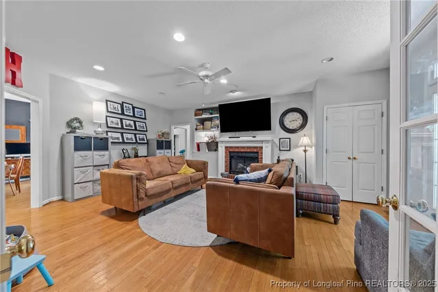 a living room with furniture a fireplace and a flat screen tv